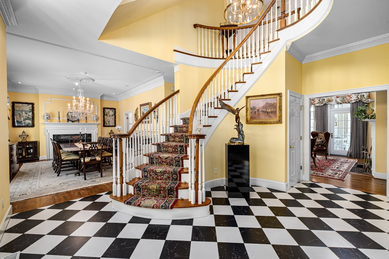 Grand staircase with intricate decor in a classic, cozy home interior setting.