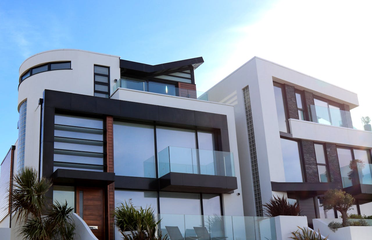 experience-img Contemporary luxury home with glass balconies in Poole, UK, showcasing modern architectural design.